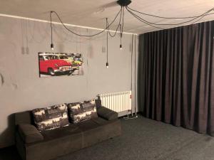 a living room with a couch and a picture of a bus at Mini Hotel Vesna in Dnipro