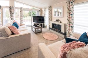 a living room with two couches and a television at The Crucible lodge with Hot Tub in York