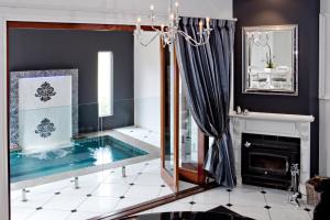 a living room with a swimming pool and a fireplace at The Castle on Tamborine in Mount Tamborine