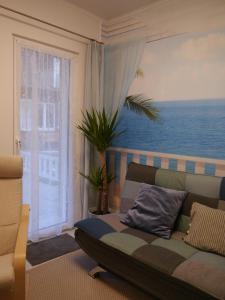 a living room with a couch in front of a window at Blaue Welle in Varel