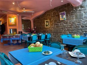 a dining room with blue tables and blue chairs at Hotel Les Arcades - La-Roche-en-Ardenne in La-Roche-en-Ardenne