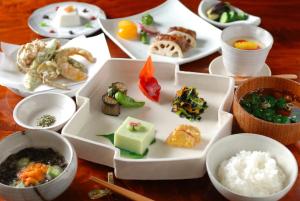 a table with plates of food and bowls of food at Katakuri no Yado in Tsunan