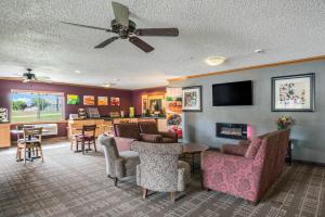 a living room with a couch and chairs and a table at Quality Inn & Suites Missoula in Missoula