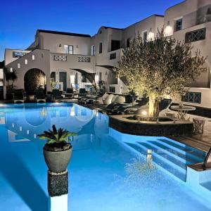 a villa with a swimming pool at night at Anastasia Princess Luxury Beach Residence - Adults Only in Perissa