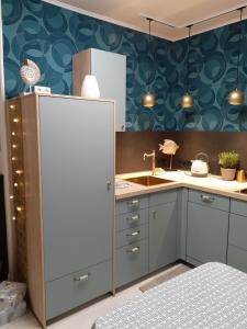 a kitchen with a white refrigerator and a sink at Blaue Welle in Varel