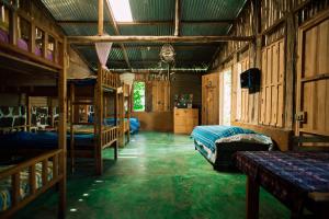 a room with three bunk beds and a green floor at Eco-Hotel Mayachik in San Juan La Laguna +117 photos
