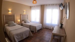 Postel nebo postele na pokoji v ubytování Hostal Santiago