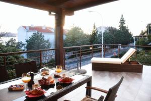 a table with food and drinks on a balcony at Selce Holiday in Selce