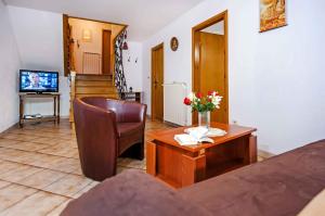a living room with a table with flowers on it at Apartment in Rovinj with Two-Bedrooms 5 in Štanga