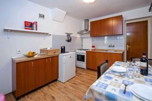 a kitchen with a table and a kitchen with a table and a tableablish at Apartment in Rovinj/Istrien 11562 in Štanga