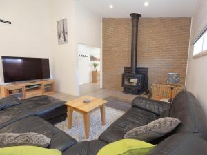 a living room with a couch and a fireplace at Jindalee 3 34 Twynam St in Jindabyne