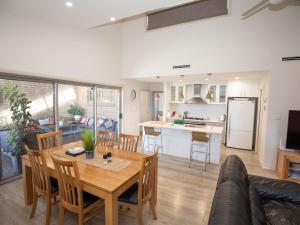 a kitchen and living room with a table and chairs at Jindalee 3 34 Twynam St in Jindabyne
