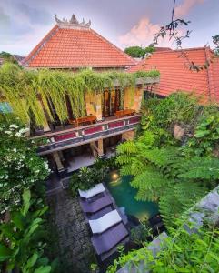 an overhead view of a house with a pond and chairs at Donald Home Stay in Ubud