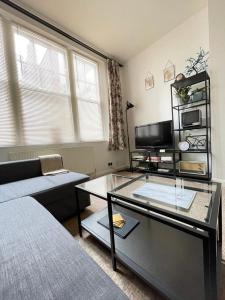a living room with a couch and a glass table at Central Located Two Bedroom Suite in Bristol