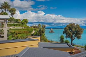 a view of the ocean from a house at On The Rocks in Nelson