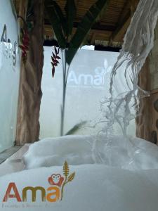 a snow covered table with a plant in the snow at Ama Ecolodge in Puerto Misahuallí