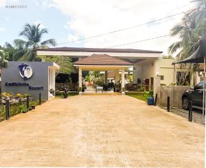 a house with a dirt road in front of it at Amphitrite Resort in Panglao Island