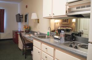 a kitchen with a stove top oven and a sink at Siegel Select Flamingo in Las Vegas
