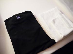a black skirt and a white shirt on a table at First Cabin Kansai Airport in Izumi-Sano