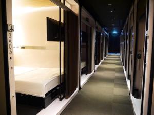 a row of bunk beds in a room at First Cabin Kansai Airport in Kashōji