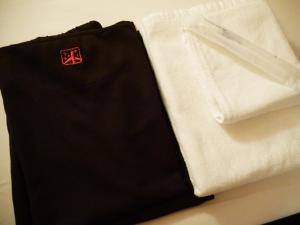 a white shirt with a red emblem on it at First Cabin Kansai Airport in Izumi-Sano