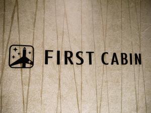 a sign that says first cabin on the side of a book at First Cabin Kansai Airport in Izumi-Sano