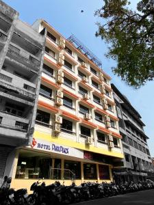 a large building with motorcycles parked in front of it at Hotel Park Plaza in Panaji