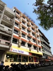 a large building with motorcycles parked in front of it at Hotel Park Plaza in Panaji