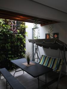 a patio with a table and a plant at Bale Resident in Jakarta