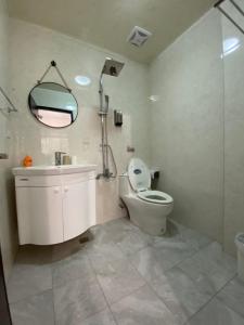 a bathroom with a shower and a toilet and a sink at Park Oasis in Tainan