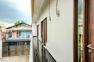 a balcony with a view of a house at Rudi Rooms near Stasiun Cikarang Mitra RedDoorz in Jakarta +23 photos