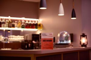 a bar with a sign on top of a counter at Hotel Victoria Lyon Perrache Confluence in Lyon