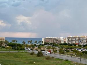a view of a parking lot with buildings and the ocean at Estudio I Loft, La Pineda, Salou, playa, Port Aventura in La Pineda +18 photos