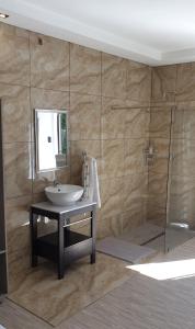 a bathroom with a sink and a shower at Casa Mo Boutique Guest House in Bloemfontein +35 photos