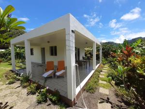 a small house with orange chairs on a patio at Fare o'Eden in Bora Bora