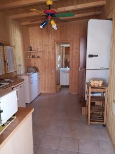 a kitchen with white appliances and a ceiling fan at Lido di Sesto in Sesto Calende