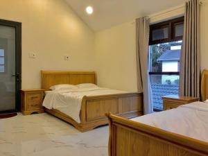Postel nebo postele na pokoji v ubytování Cánh Đồng Mây Homestay Đà Lạt