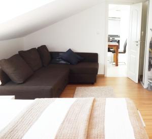 a living room with a couch and a table at Schöne Wohnungen am Bahnhof in Dachau - S-Bahn direkt zu München Zentrum in Dachau