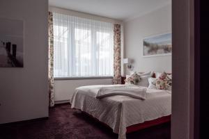 En eller flere senge i et værelse på Garni Hotel & Appartements Nordstrand