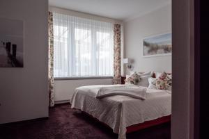 Postel nebo postele na pokoji v ubytování Garni Hotel & Appartements Nordstrand