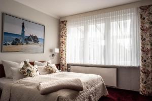 Postel nebo postele na pokoji v ubytování Garni Hotel & Appartements Nordstrand
