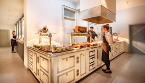 a group of people in a kitchen preparing food at Hotel Imperial - Liburnia in Opatija