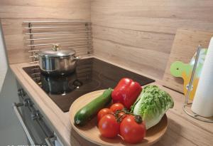 a plate of vegetables on a counter in a kitchen at Ferienwohnung Richter in Kirchhundem