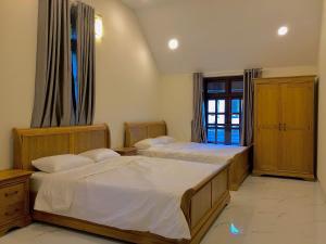 En eller flere senge i et værelse på Cánh Đồng Mây Homestay Đà Lạt