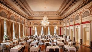 a large dining room with tables and a chandelier at Hotel Imperial - Liburnia in Opatija