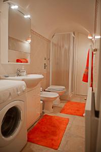 a bathroom with a washing machine and a washer at Campo Appartamenti in Trapani