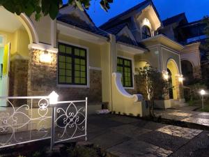 a house with a gate in front of it at night at Villa kota bunga cipanas 3 kamar baru in Cikundul