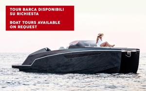 a woman sitting on a boat in the water at Milestone in Quartu SantʼElena