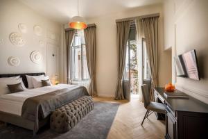 a bedroom with a bed and a desk and a window at Hotel Imperial - Liburnia in Opatija