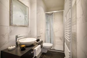 a white bathroom with a sink and a toilet at Hotel Imperial - Liburnia in Opatija